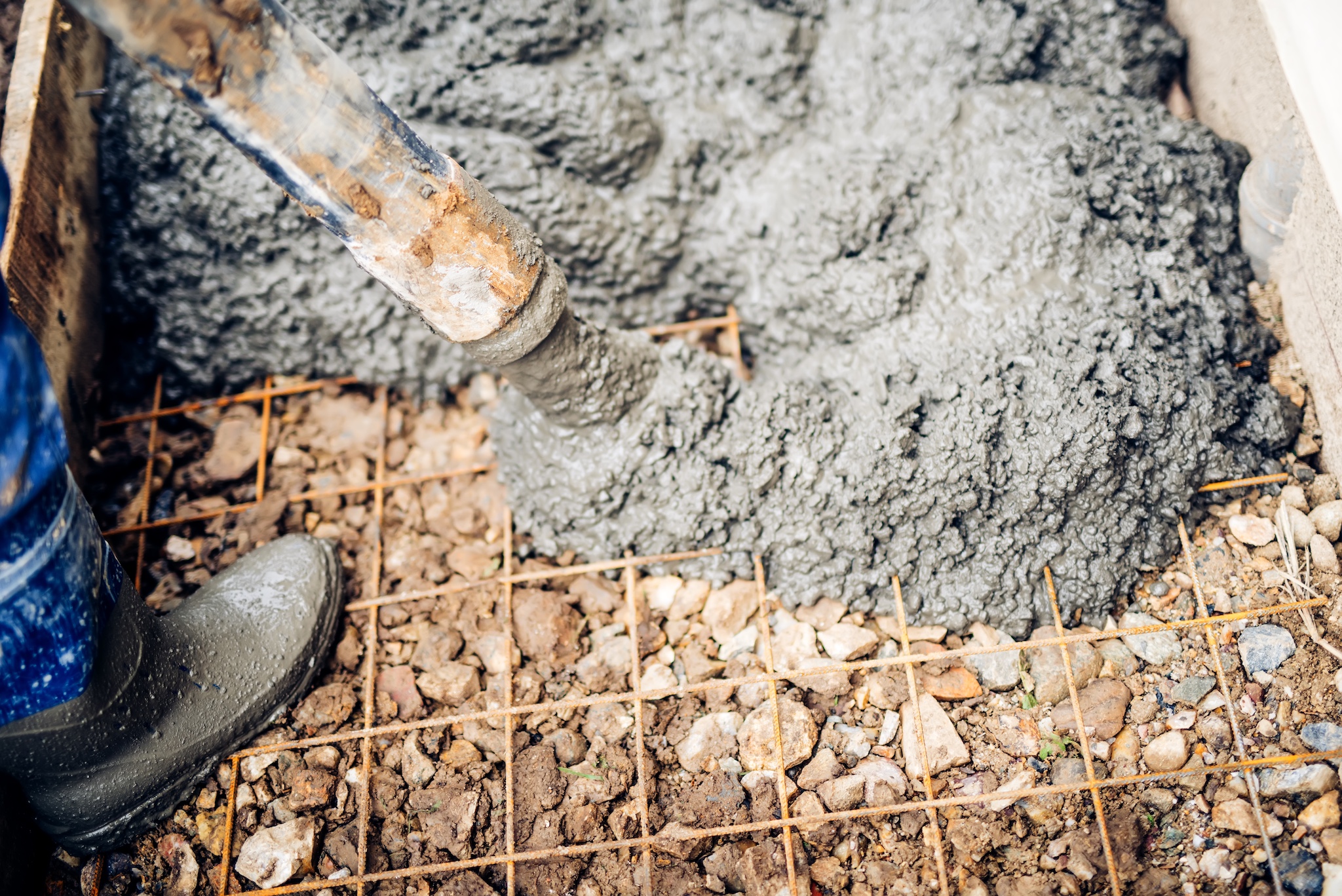 Construction Workers Using Cement Pump